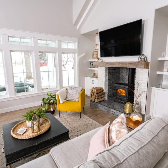 modern farmhouse with fireplace, tv and yellow chair